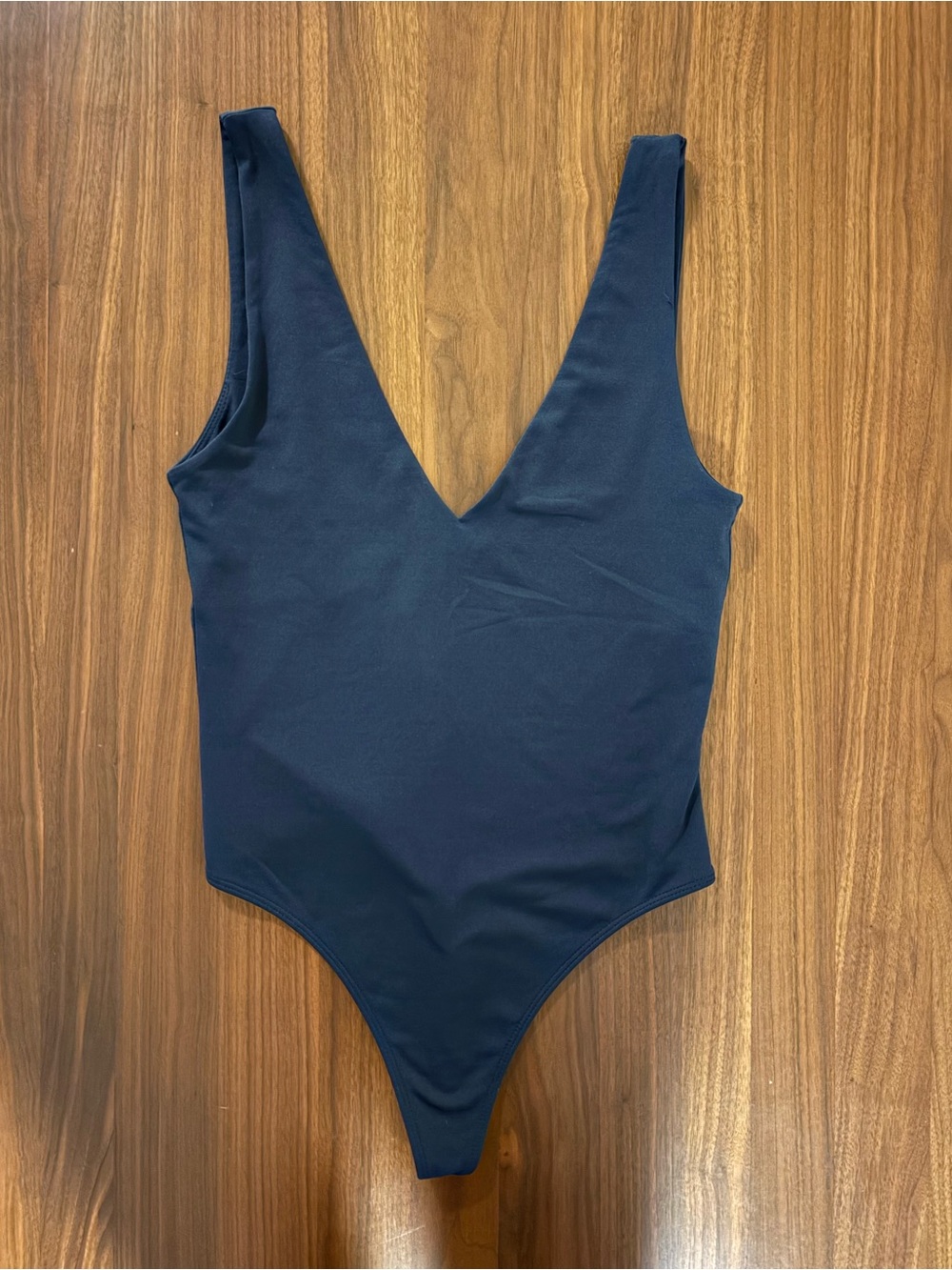 classic Babaton black bodysuit. Featuring a flattering deep V neckline